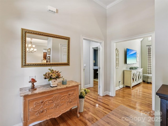 145 Fernbrook Way, Hendersonville, NC 28791 - hall featuring crown molding, light wood finished floors, and a chandelier