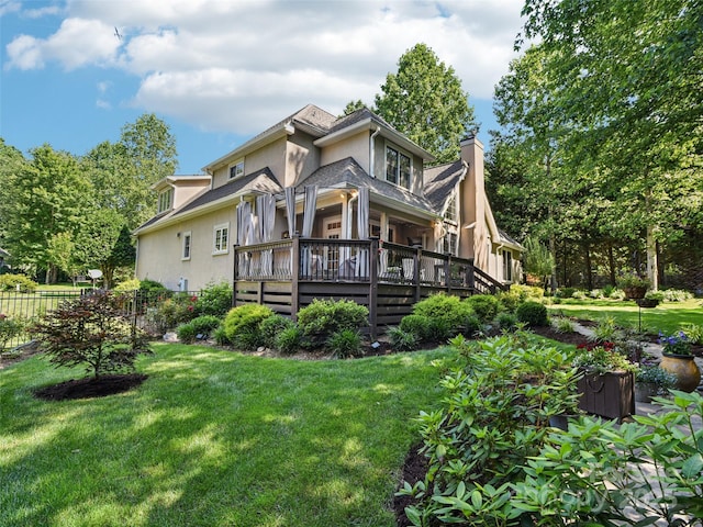 145 Fernbrook Way, Hendersonville, NC 28791 - rear view of house with stucco siding, a wooden deck, and a chimney