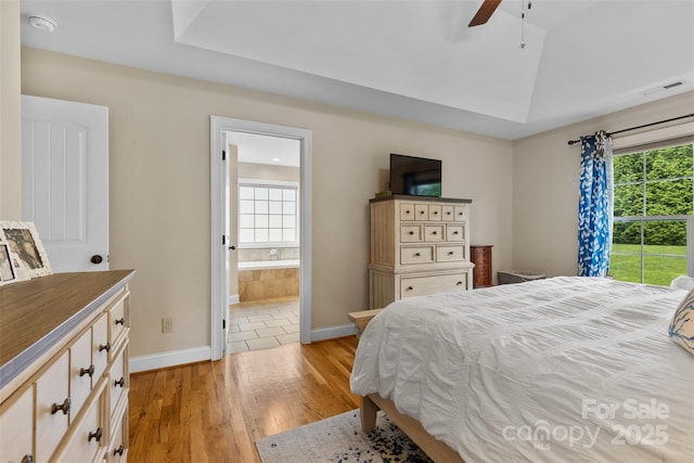 121 Maplewood Ct, Hudson, NC 28638 - bedroom featuring light wood-style floors, multiple windows, connected bathroom, and ceiling fan