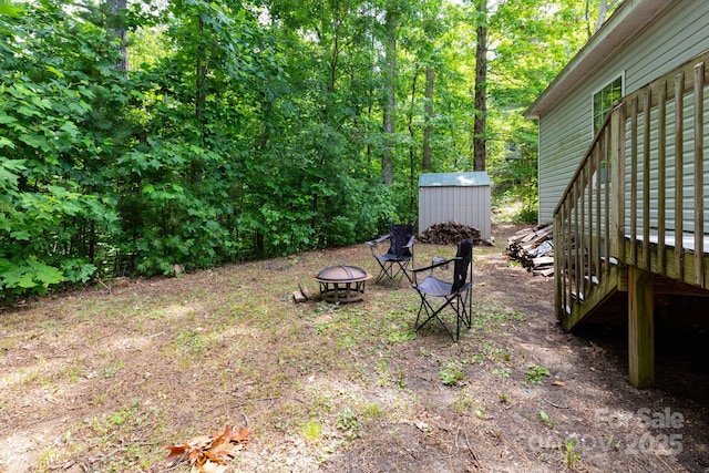 16 Rusty Clay Rdg, Fairview, NC 28730 - view of yard featuring a fire pit, a storage unit, and a wooden deck