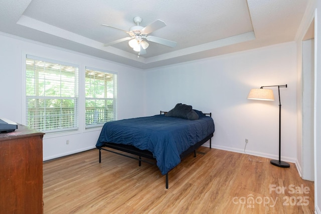 16 Rusty Clay Rdg, Fairview, NC 28730 - bedroom featuring a raised ceiling, light wood-style floors, and a ceiling fan