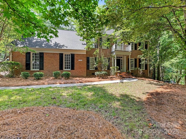 10333 Scott Gate Ct, Charlotte, NC 28277 - view of front of home with a balcony, brick siding, a front yard, and a shingled roof