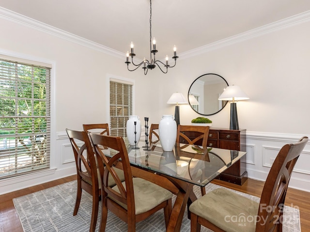 10333 Scott Gate Ct, Charlotte, NC 28277 - dining space with a chandelier, wood finished floors, crown molding, a decorative wall, and wainscoting