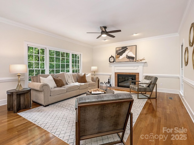 10333 Scott Gate Ct, Charlotte, NC 28277 - living area featuring ceiling fan, wood finished floors, crown molding, and a brick fireplace