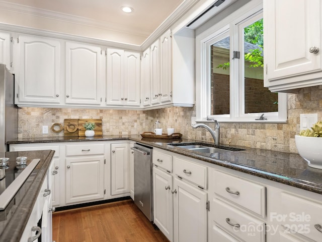 10333 Scott Gate Ct, Charlotte, NC 28277 - kitchen with appliances with stainless steel finishes, white cabinetry, dark stone countertops, wood finished floors, and crown molding