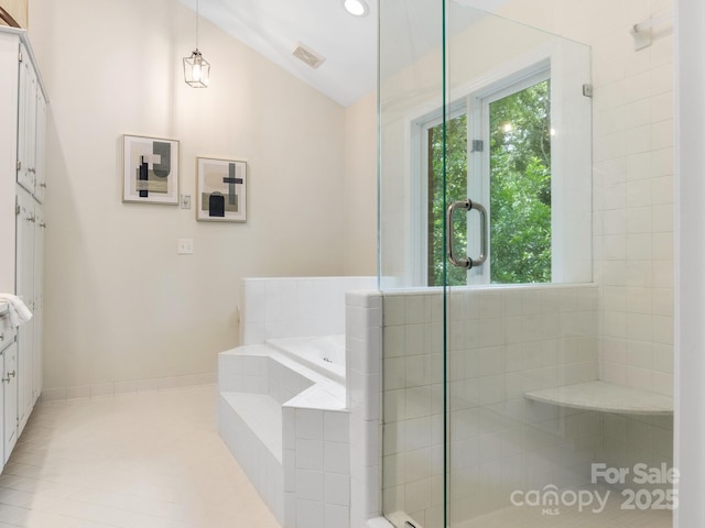 10333 Scott Gate Ct, Charlotte, NC 28277 - full bathroom with plenty of natural light, a bath, tiled shower, lofted ceiling, and tile patterned flooring