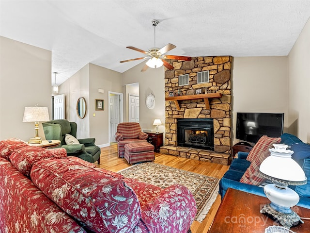 128 View De Lake Dr, Etowah, NC 28729 - living area featuring ceiling fan, wood finished floors, a textured ceiling, lofted ceiling, and a fireplace