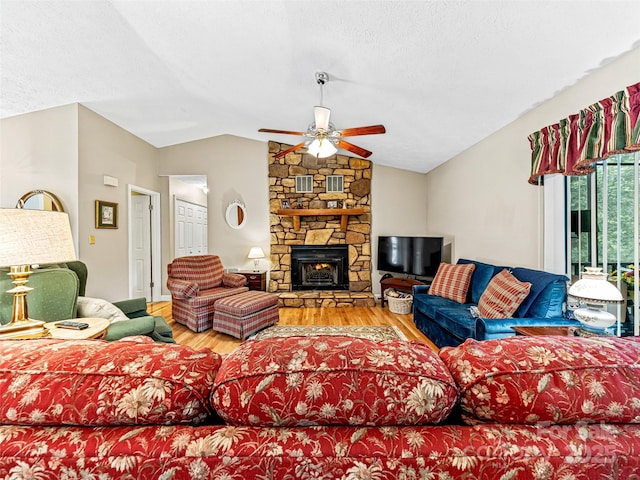 128 View De Lake Dr, Etowah, NC 28729 - living room with vaulted ceiling, wood finished floors, ceiling fan, and a fireplace