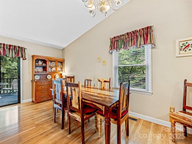 128 View De Lake Dr, Etowah, NC 28729 - dining room featuring a chandelier and light wood-style floors