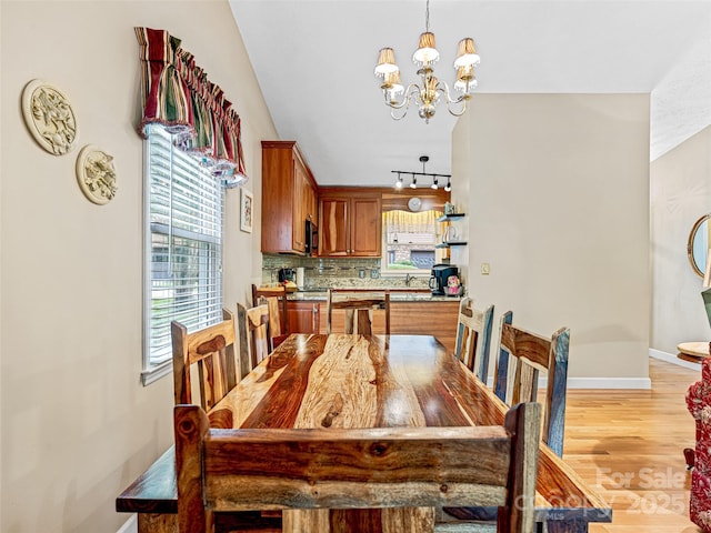 128 View De Lake Dr, Etowah, NC 28729 - dining space with a chandelier and light wood-style flooring