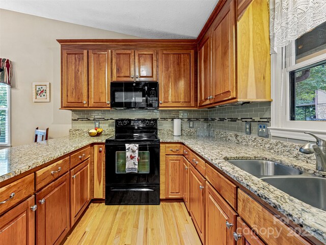 128 View De Lake Dr, Etowah, NC 28729 - kitchen with black appliances, light wood-type flooring, healthy amount of natural light, backsplash, and lofted ceiling