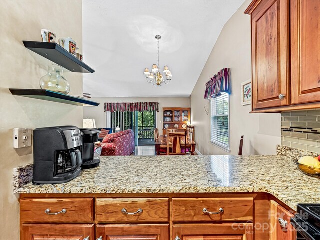 128 View De Lake Dr, Etowah, NC 28729 - kitchen featuring plenty of natural light, brown cabinets, vaulted ceiling, tasteful backsplash, and a chandelier