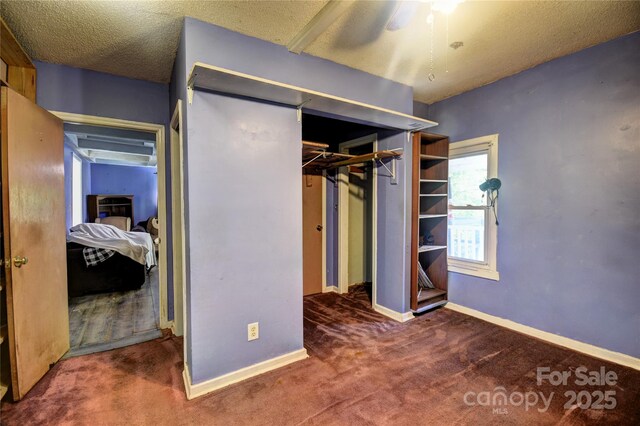 161 Pandora Cir, Canton, NC 28716 - unfurnished bedroom featuring carpet, a closet, a textured ceiling, and ceiling fan