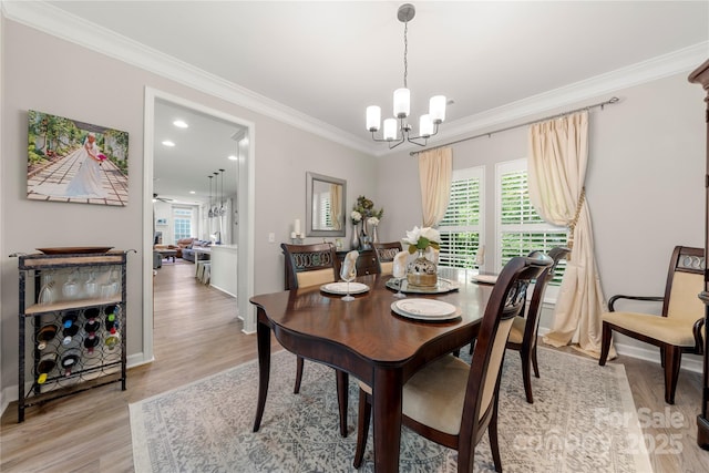 1125 Victoria Blake Ln, Belmont, NC 28012 - dining space with a chandelier, crown molding, and light wood finished floors