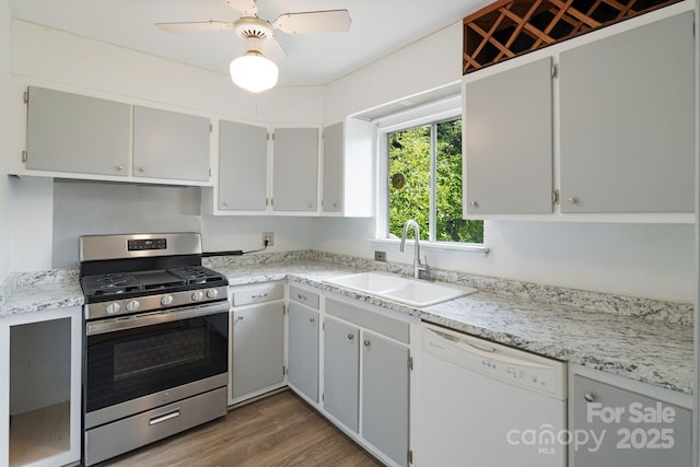 55 Lookout Dr, Asheville, NC 28804 - kitchen with stainless steel gas range, white dishwasher, wood finished floors, and light countertops