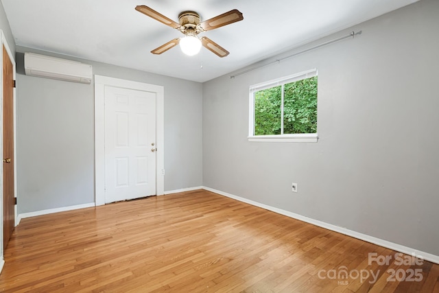55 Lookout Dr, Asheville, NC 28804 - unfurnished bedroom with a wall unit AC, light wood-style floors, a closet, and ceiling fan