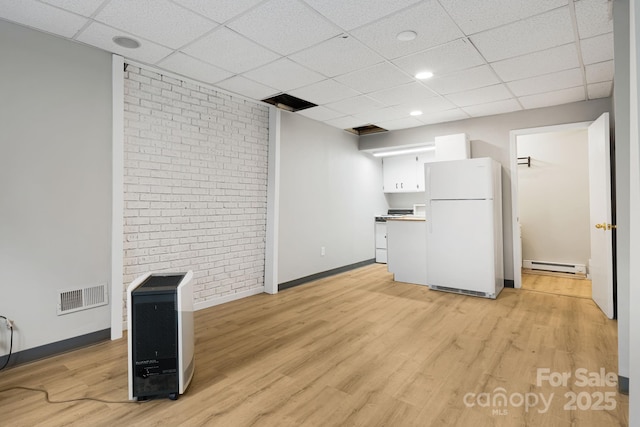 55 Lookout Dr, Asheville, NC 28804 - unfurnished living room with baseboard heating, a drop ceiling, light wood finished floors, recessed lighting, and brick wall