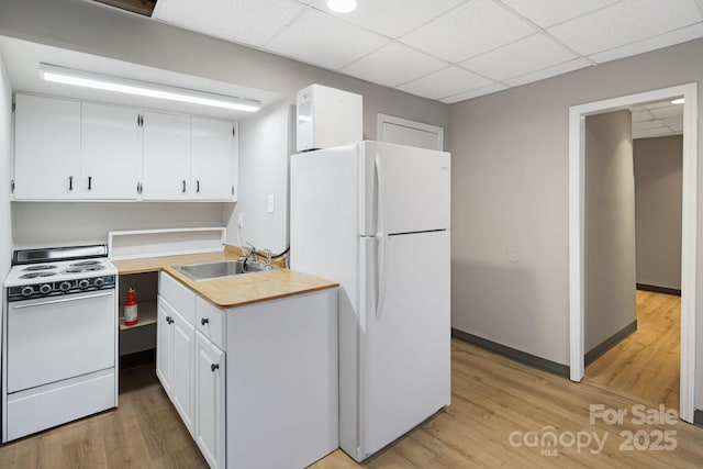 55 Lookout Dr, Asheville, NC 28804 - kitchen with white appliances, a drop ceiling, white cabinetry, and light wood-style flooring