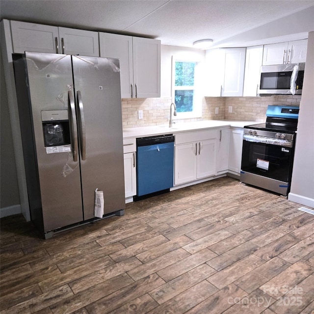 105 Damron Ln Unit 20, Harmony, NC 28634 - kitchen with appliances with stainless steel finishes, light countertops, backsplash, and a textured ceiling