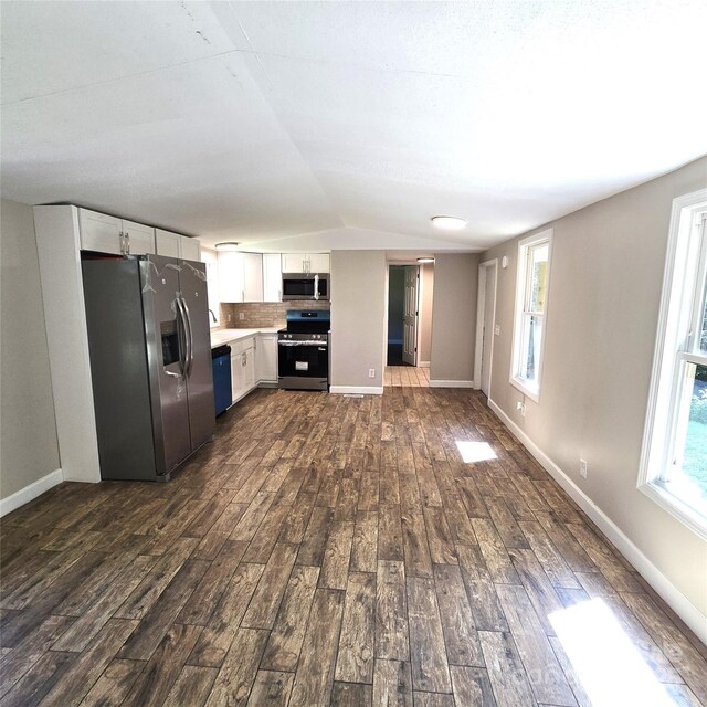 105 Damron Ln Unit 20, Harmony, NC 28634 - kitchen featuring appliances with stainless steel finishes, dark wood-style flooring, light countertops, white cabinetry, and lofted ceiling