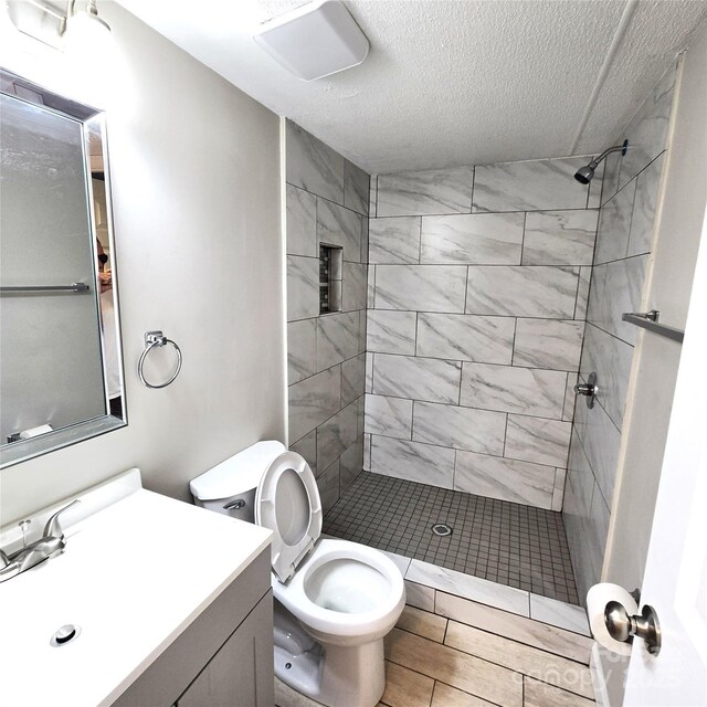 105 Damron Ln Unit 20, Harmony, NC 28634 - bathroom featuring vanity, a stall shower, a textured ceiling, and wood finished floors