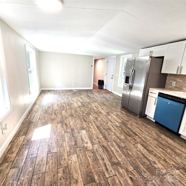 105 Damron Ln Unit 20, Harmony, NC 28634 - kitchen with dishwashing machine, dark wood-style floors, stainless steel fridge, and white cabinetry