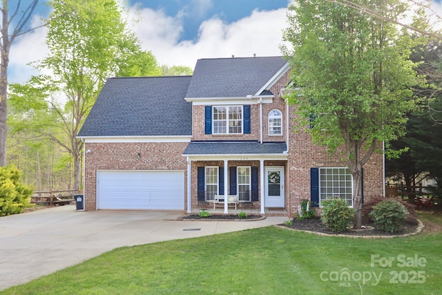 111 Painted Bunting Dr, Troutman, NC 28166 - view of front of home featuring brick siding, concrete driveway, covered porch, and roof with shingles