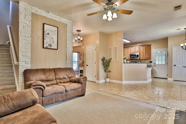 111 Painted Bunting Dr, Troutman, NC 28166 - living room featuring a chandelier, stairs, ceiling fan, and healthy amount of natural light
