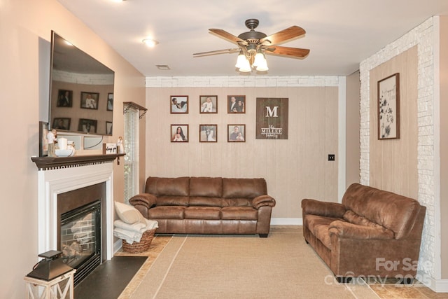 111 Painted Bunting Dr, Troutman, NC 28166 - living area featuring ceiling fan, a glass covered fireplace, and an accent wall