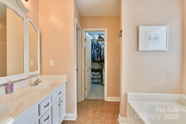 111 Painted Bunting Dr, Troutman, NC 28166 - full bathroom featuring double vanity, a garden tub, and a walk in closet