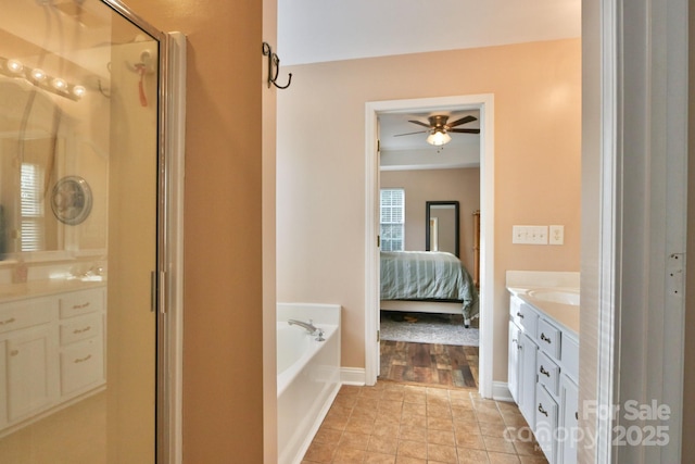 111 Painted Bunting Dr, Troutman, NC 28166 - bathroom featuring vanity, a stall shower, a garden tub, ceiling fan, and ensuite bath