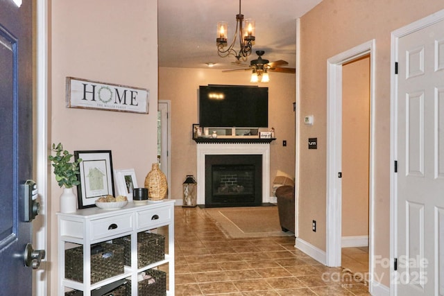 111 Painted Bunting Dr, Troutman, NC 28166 - foyer with a glass covered fireplace, tile patterned flooring, a ceiling fan, and a chandelier