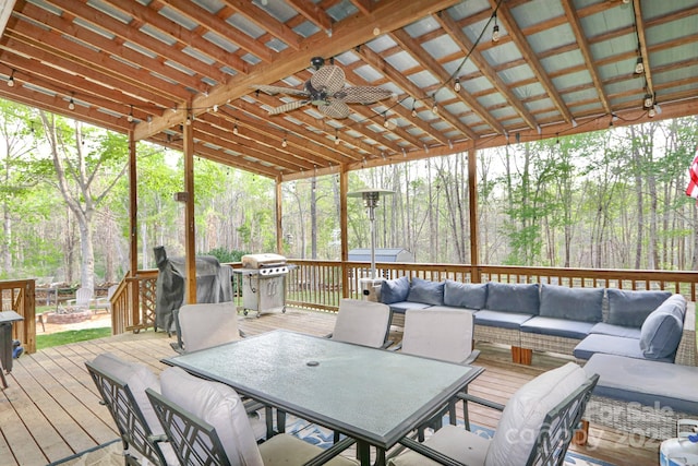 111 Painted Bunting Dr, Troutman, NC 28166 - wooden terrace with outdoor dining space, an outdoor living space with a fire pit, ceiling fan, and a grill