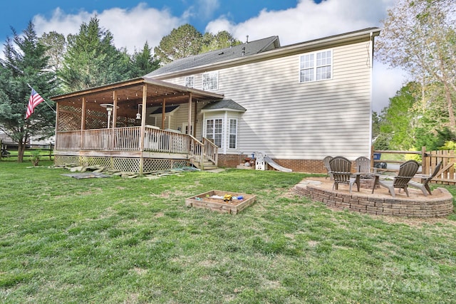 111 Painted Bunting Dr, Troutman, NC 28166 - rear view of property featuring a wooden deck, a patio area, and a fire pit