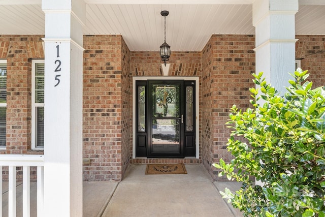 125 Snow Fountain Ln, Mooresville, NC 28115 - doorway to property featuring brick siding and a porch