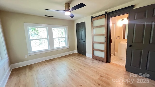 616 W Marion St, Shelby, NC 28150 - spare room with ceiling fan, light wood finished floors, and a barn door