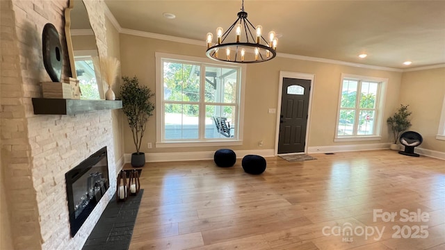 616 W Marion St, Shelby, NC 28150 - exercise area featuring plenty of natural light, light wood-style floors, a stone fireplace, a chandelier, and ornamental molding