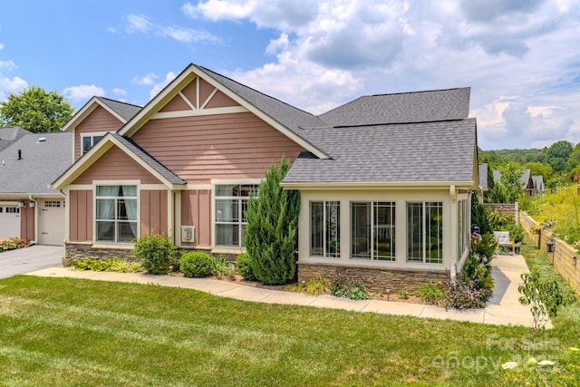 38 Westfield Way, Candler, NC 28715 - view of front facade with stone siding, roof with shingles, board and batten siding, concrete driveway, and a garage