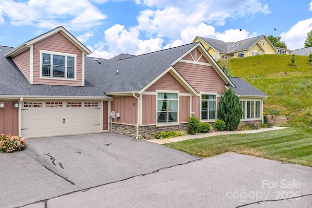 38 Westfield Way, Candler, NC 28715 - craftsman house featuring board and batten siding, stone siding, a shingled roof, driveway, and a front lawn