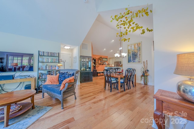 38 Westfield Way, Candler, NC 28715 - dining space with a chandelier, high vaulted ceiling, and light wood-style floors