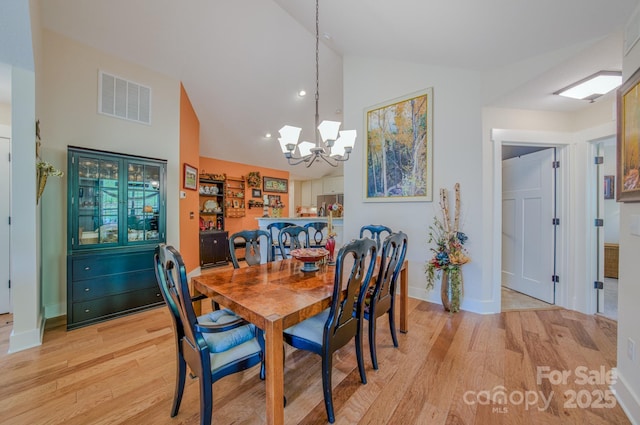 38 Westfield Way, Candler, NC 28715 - dining space with light wood-style flooring, a chandelier, high vaulted ceiling, and recessed lighting