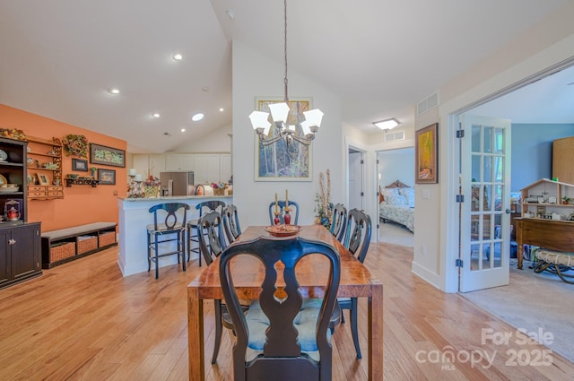 38 Westfield Way, Candler, NC 28715 - dining space with light wood-type flooring, a chandelier, high vaulted ceiling, recessed lighting, and french doors