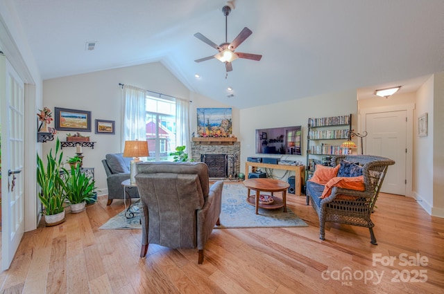 38 Westfield Way, Candler, NC 28715 - living area featuring light wood-style floors, lofted ceiling, a stone fireplace, and a ceiling fan