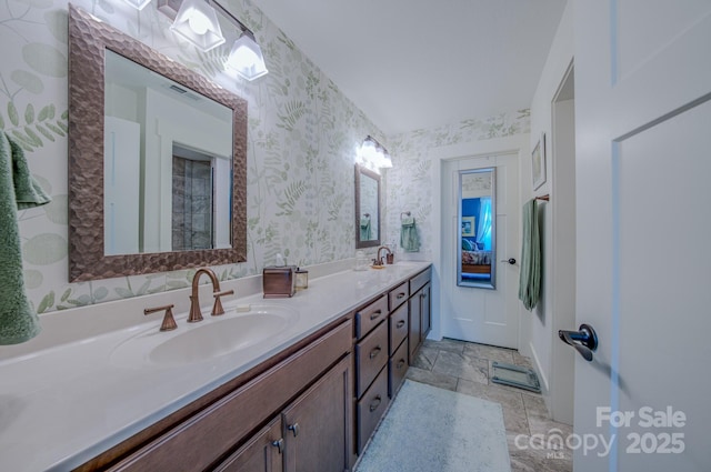 38 Westfield Way, Candler, NC 28715 - bathroom featuring wallpapered walls, double vanity, and stone finish floors