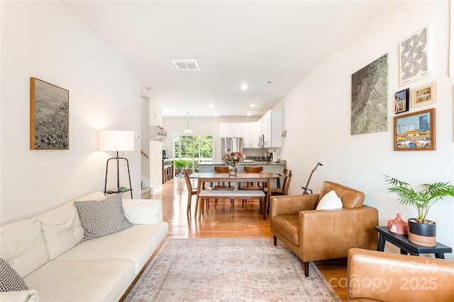 6507 Revolutionary Trl, Charlotte, NC 28217 - living area featuring light wood-type flooring, stairs, and recessed lighting