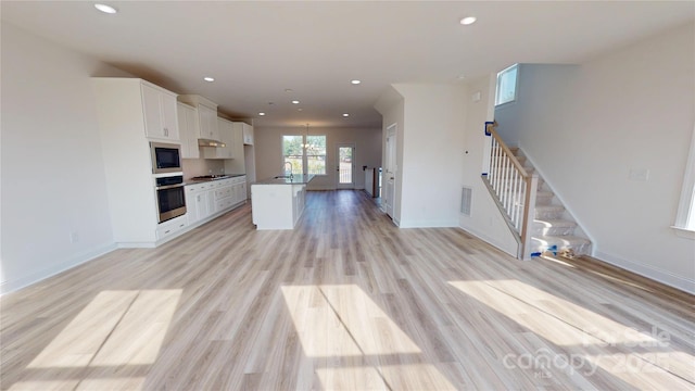 2143 Barrowcliffe Dr NW, Concord, NC 28027 - kitchen with stainless steel oven, built in microwave, white cabinets, open floor plan, and recessed lighting