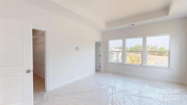 2143 Barrowcliffe Dr NW, Concord, NC 28027 - unfurnished room featuring light colored carpet and a tray ceiling