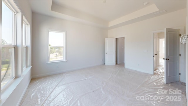 2143 Barrowcliffe Dr NW, Concord, NC 28027 - unfurnished bedroom featuring a raised ceiling and light carpet