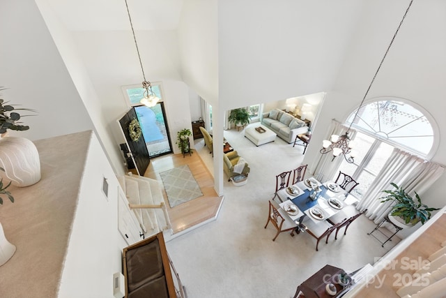 7014 Walton Heath Ln, Charlotte, NC 28277 - foyer featuring high vaulted ceiling, healthy amount of natural light, a chandelier, and carpet