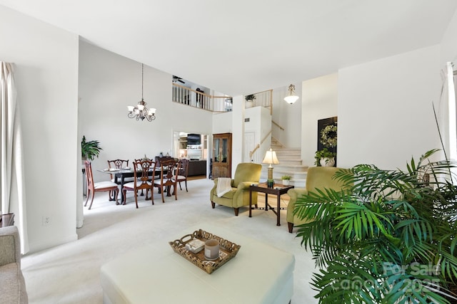 7014 Walton Heath Ln, Charlotte, NC 28277 - living room with light colored carpet, stairs, a chandelier, and a high ceiling